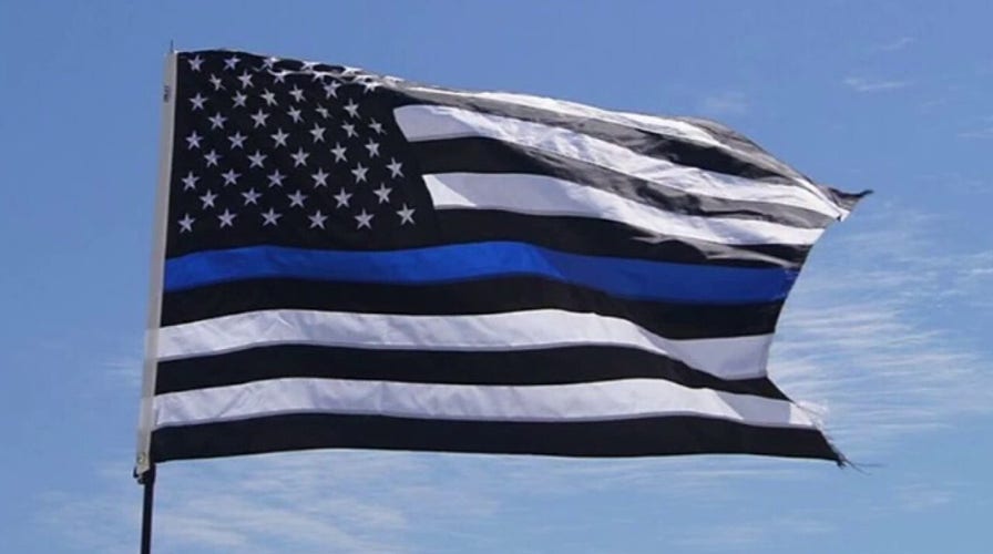 School district restricts Thin Blue Line flags after football players carried one to honor coach