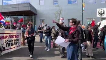 Protesters march through South Minneapolis, carry political signs
