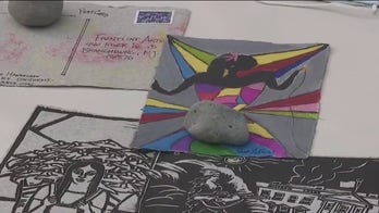 Front-line workers honored with 'combat paper' art made from scrubs, military uniforms