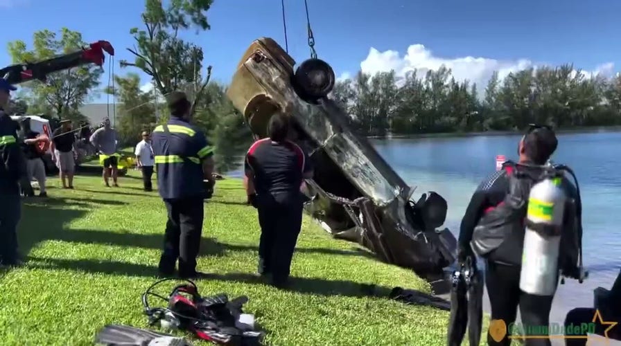 Miami-Dade police department divers dredge up 32 cars from a lake in Doral, Florida