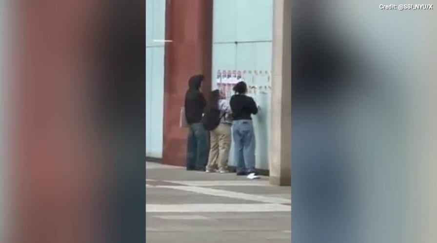 Individuals tear down photos of Israeli hostages on NYU’s campus