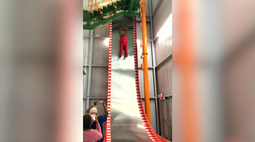 Man screams, refuses to go down 32-foot slide