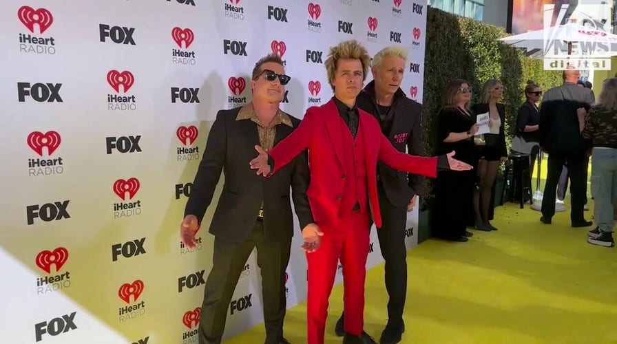 Members of Green Day walk the carpet at the 2024 iHeartRadio Music Awards