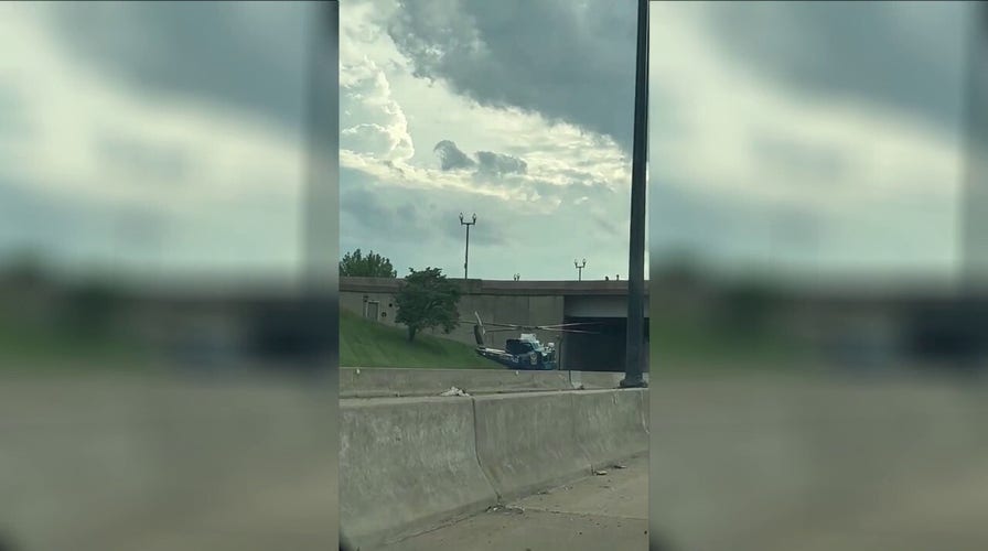 US Park Police helicopter lands on freeway to rescue motorcycle officer after accident