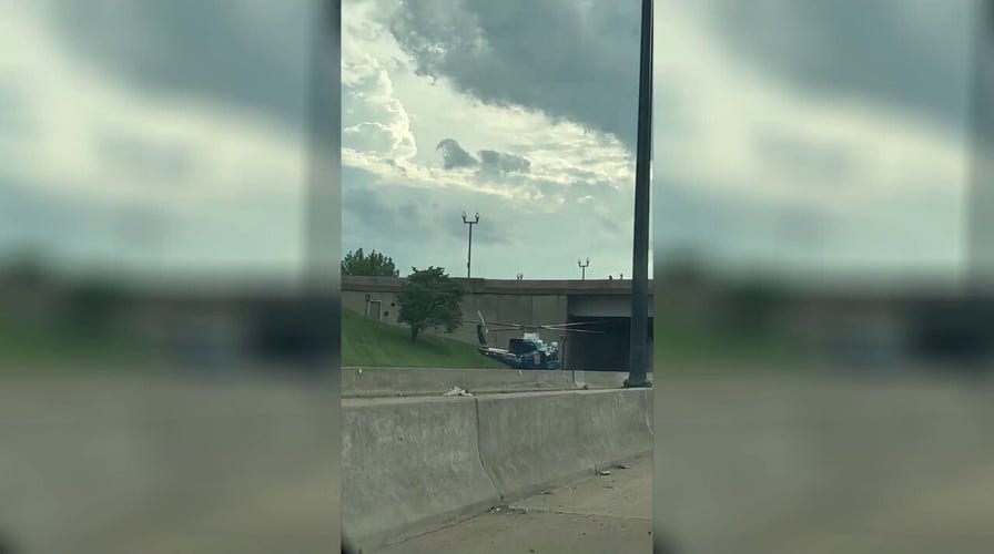 US Park Police helicopter lands on freeway to rescue motorcycle officer after accident