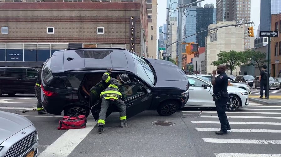 NYC firefighter gets trapped under SUV during rescue before bystanders save him