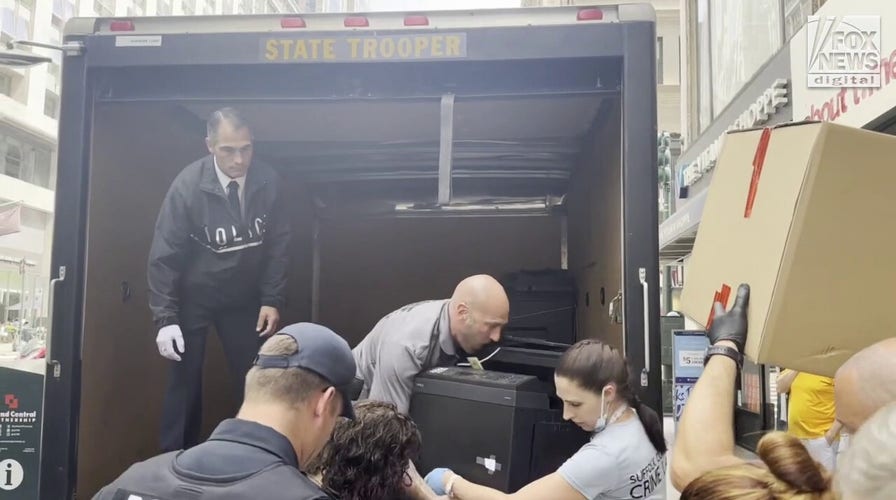 Police load up evidence outside Gilgo Beach murders suspect's office building