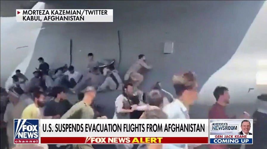 Afghans cling to departing planes, US suspends evacuation flights from Kabul airport