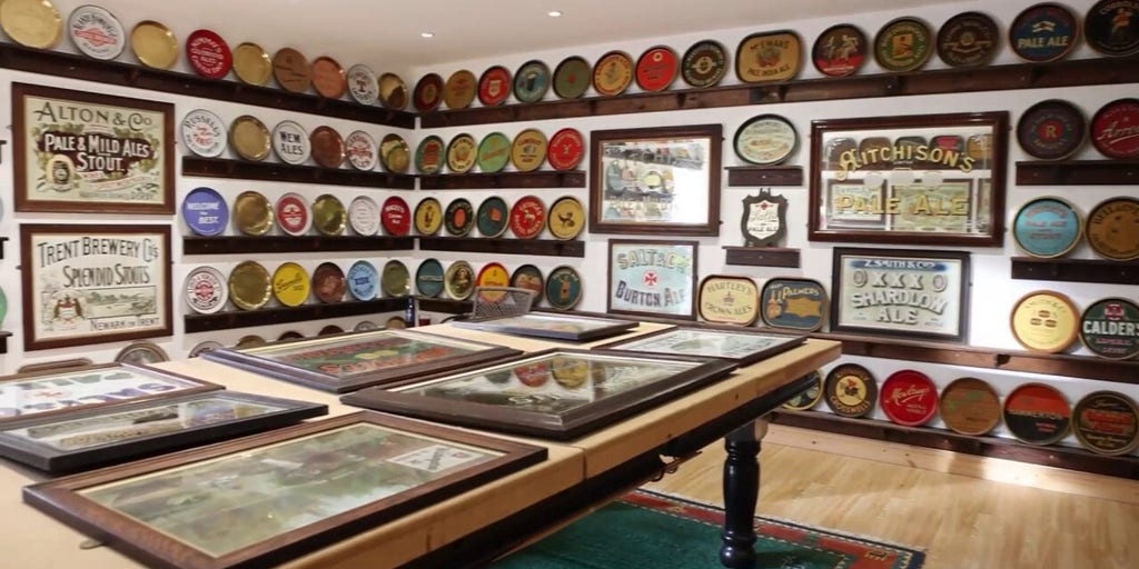 Man converts garage into beer tray museum