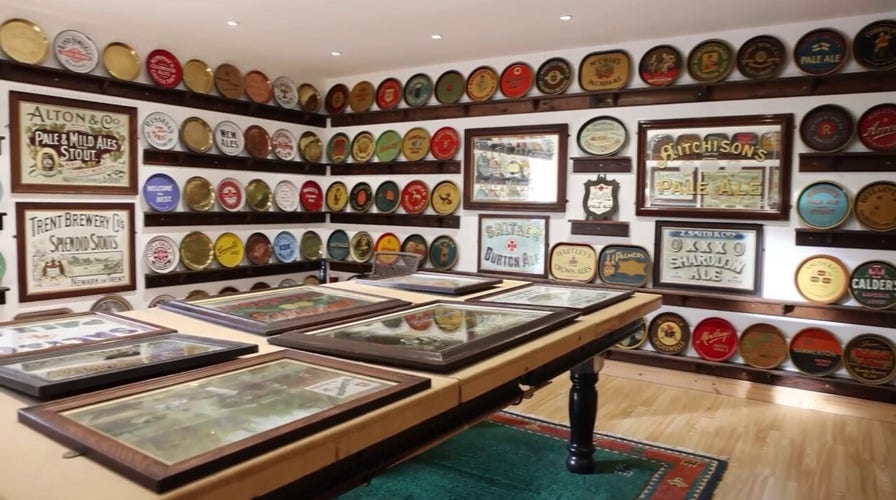 Man converts garage into beer tray museum