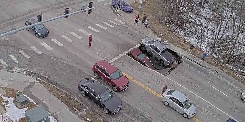 Video captures heart-dropping moment sinkhole collapses underneath multiple cars