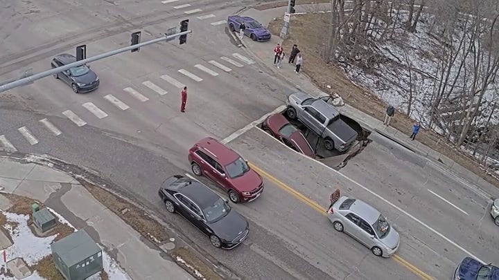 Video captures heart-dropping moment sinkhole collapses underneath multiple cars