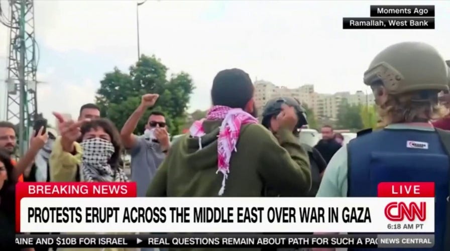 Palestinian protesters scream at CNN reporter in West Bank, security escorts her away