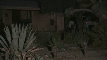 Light flashes, silhouette of a police officer seen in windows of Annie Guthrie's home