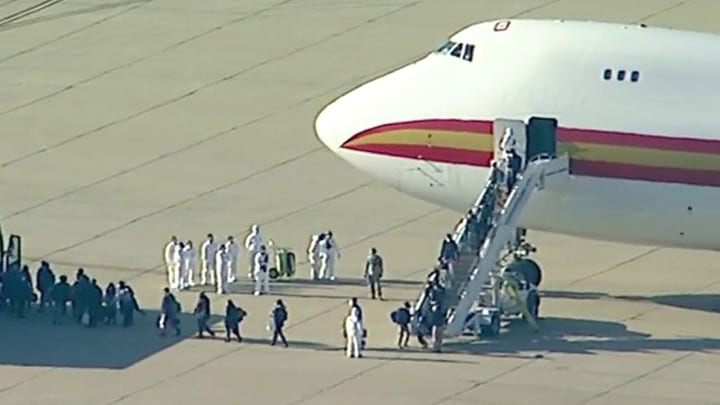 Evacuated Americans deplane from a chartered flight from Chinese epicenter of coronavirus outbreak