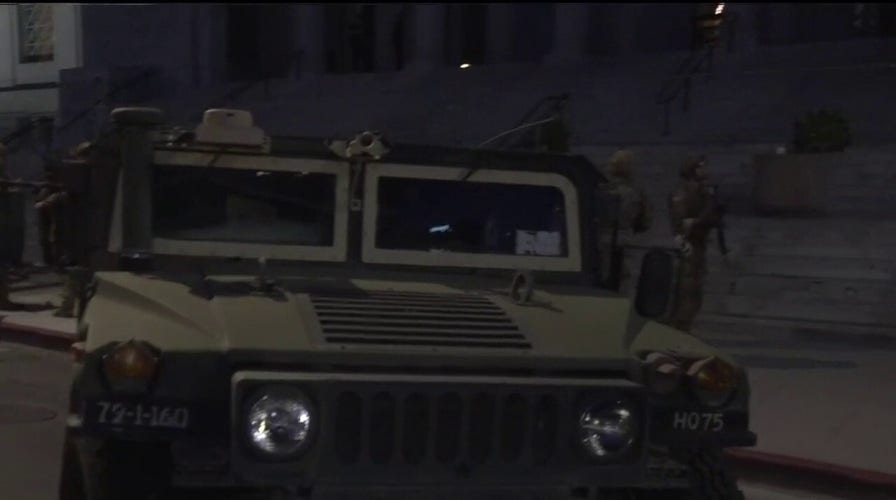 National Guard vehicles stage outside City Hall in Los Angeles
