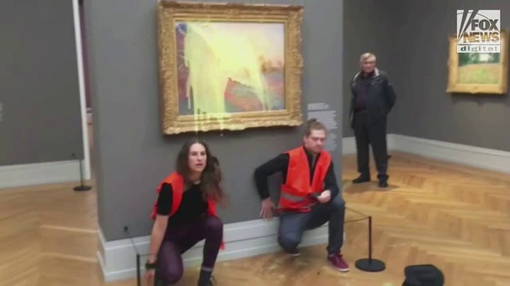 German climate change protesters throw mashed potatoes on a Monet painting