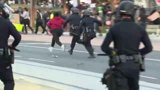 Woman runs from police during anti-ICE protest in Santa Ana