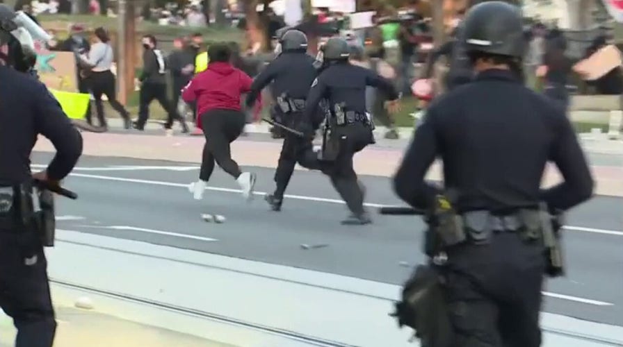 Woman runs from police during anti-ICE riot in Santa Ana