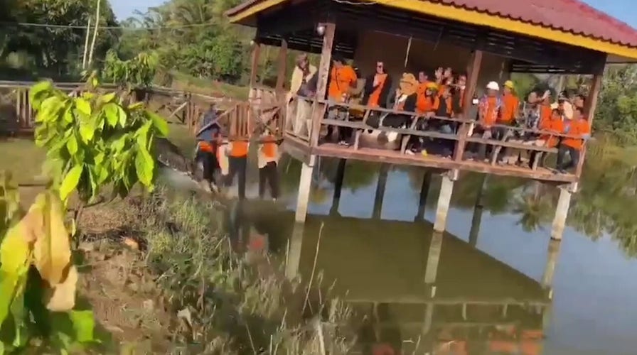 Wooden bridge collapses while tourists pose for a picture