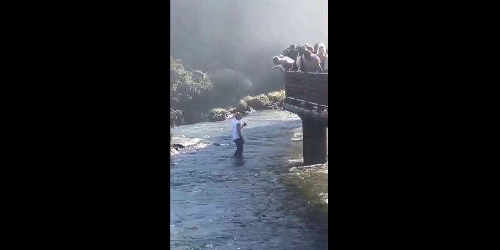 Tourist caught on camera risking deadly drop to retrieve phone at popular waterfall