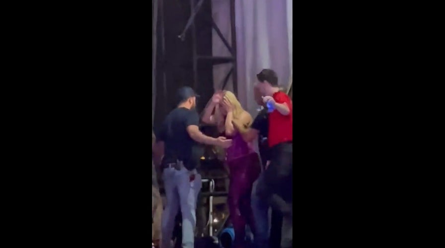 Bebe Rexha waves to fans after being hit with cell phone