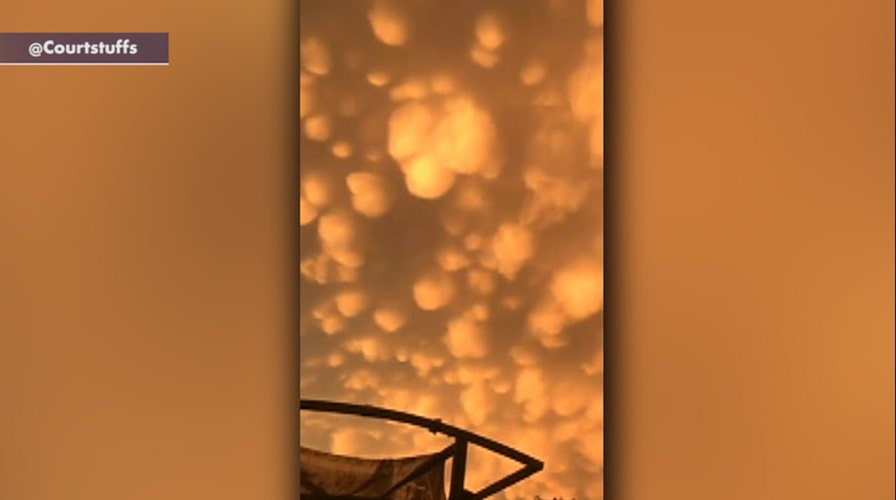 Glowing orange mammatus clouds cover the evening sky in Oklahoma after severe storm swept through
