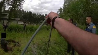Law enforcement officers lasso suspect threatening father with a chainsaw