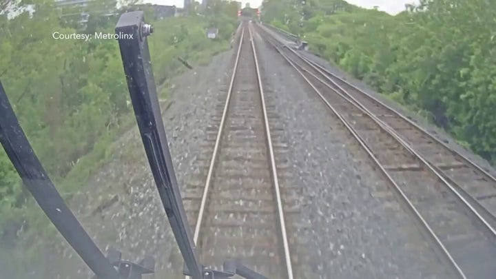 WARNING: Video may be disturbing. Teenage boys run away from a train before nearly being hit 