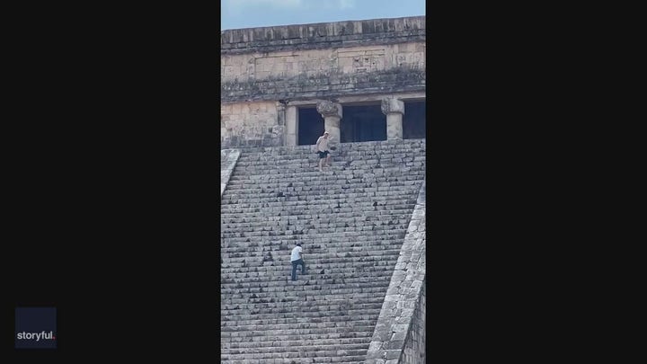 Tourist whacked with stick, heckled after climbing pyramid