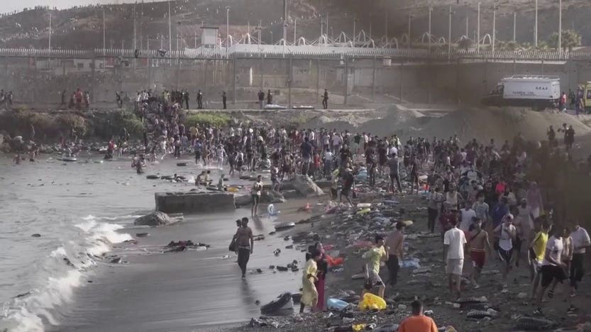 ‘We don’t have a good life’: Thousands of migrants pour into Spain