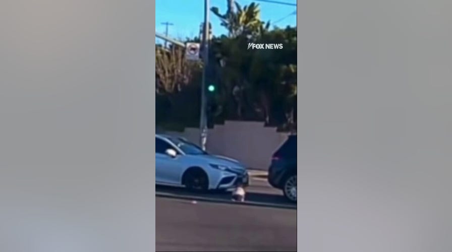 WATCH: A toddler is seen falling out of an SUV and tumbling onto a busy road