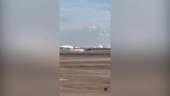 NASA aircraft slides in for a 'gear-up landing' at Houston airport