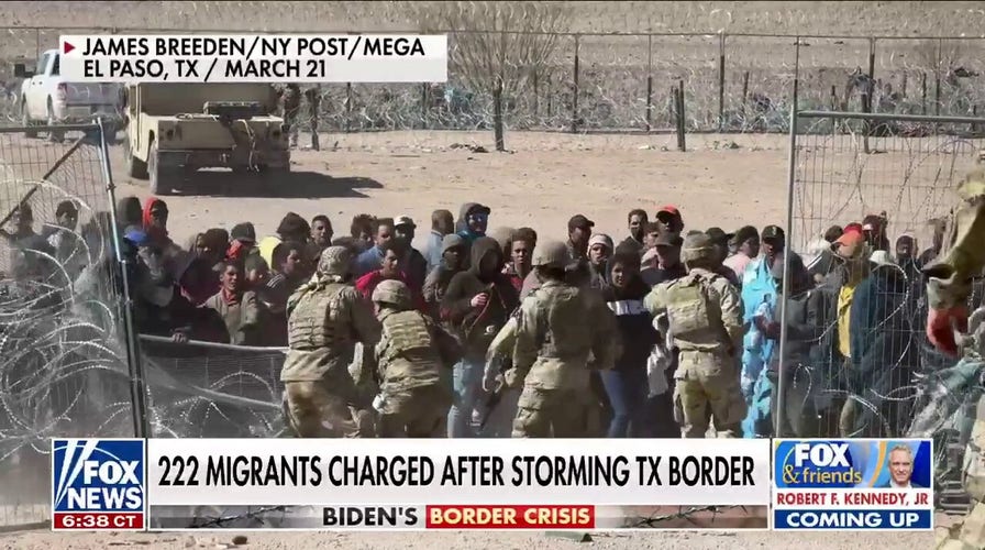 200-plus migrants charged with inciting riot after storming border
