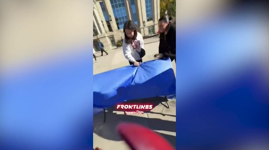 Student flips Turning Point USA table at the University of Iowa