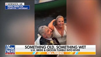 Bride and groom plunge into river during wedding photoshoot