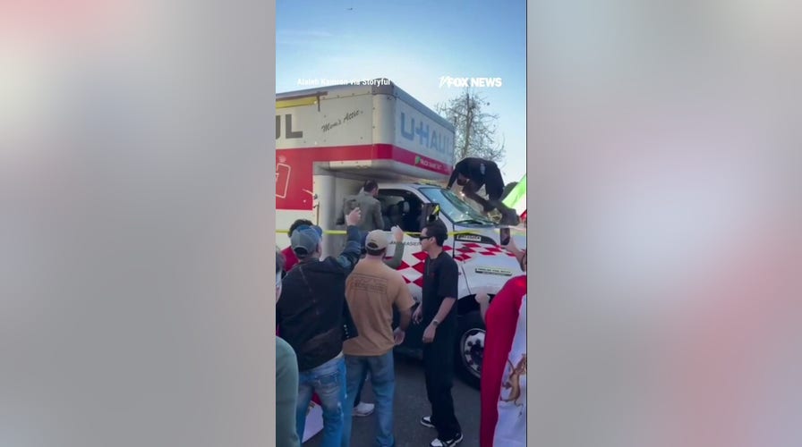 Demonstrators SWARM U-Haul after it drove through Iran protest