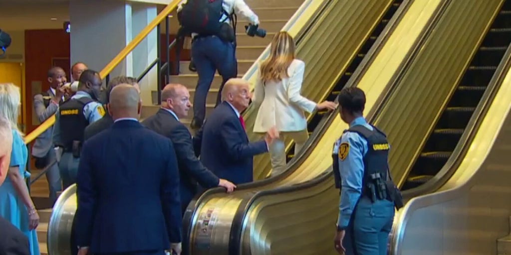 Several men seen going up UN escalator before Trump and first lady