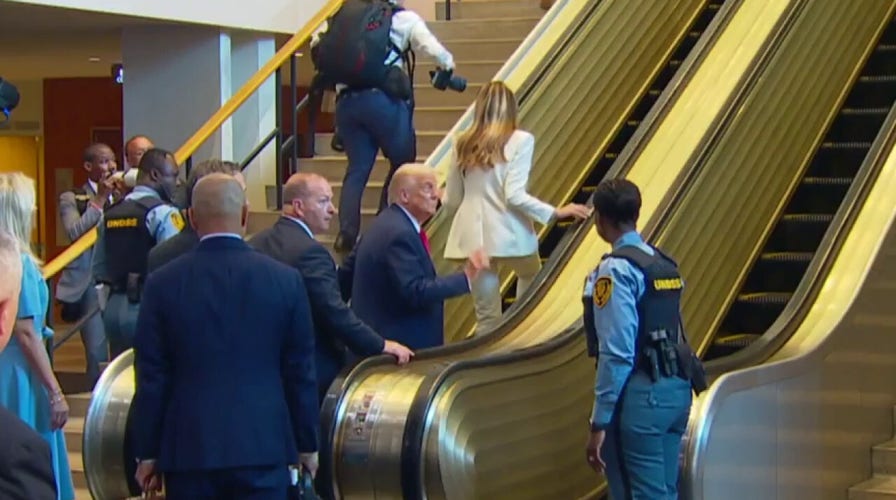 Several men seen going up UN escalator before Trump and first lady