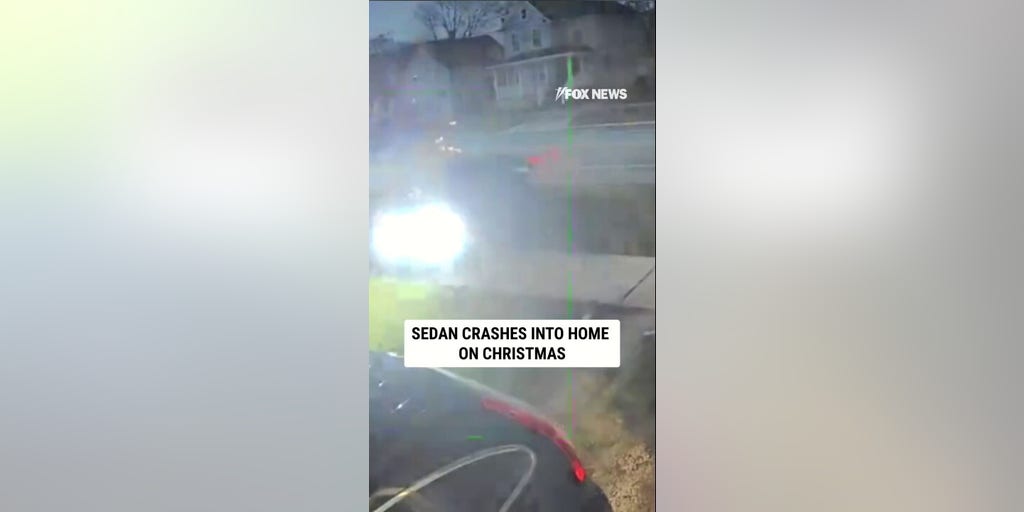 CHRISTMAS CRASH: Surveillance video shows sedan crashing into a home