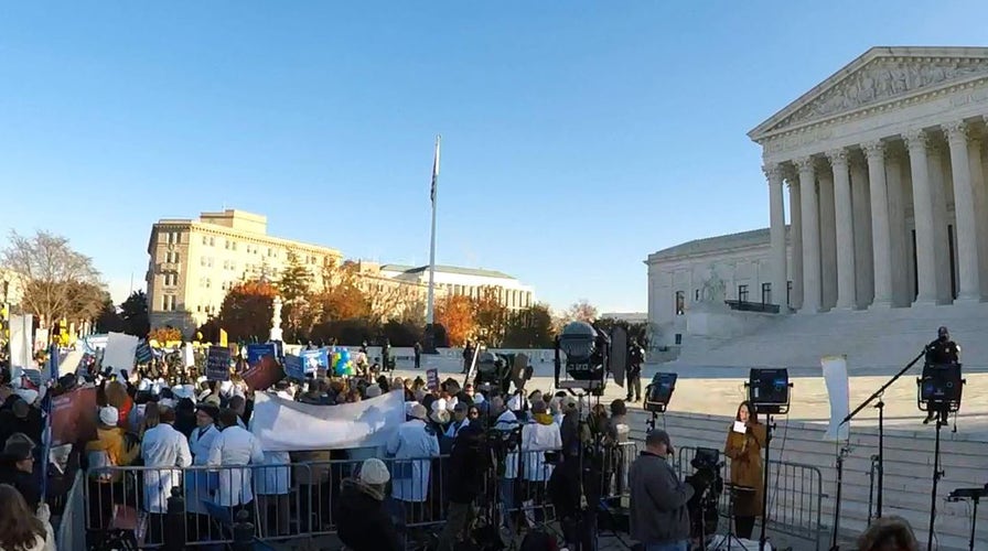 Protesters gather outside the Supreme Court ahead of landmark case