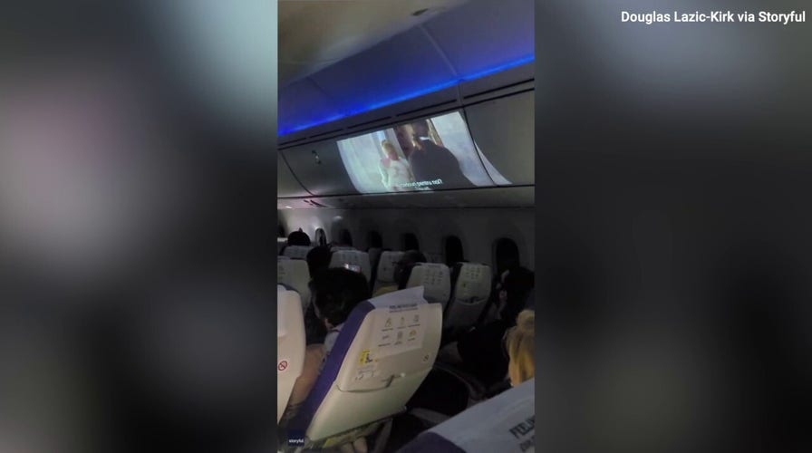 Pass the popcorn! Watch as an airline passenger gives new meaning to 'in-flight entertainment'!
