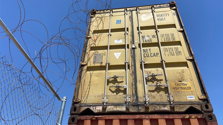 Shipping containers used to fill border wall gaps