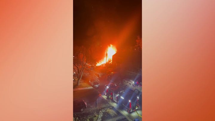 An Arlington home was engulfed in flames after an explosion as cops were trying to serve a search warrant.