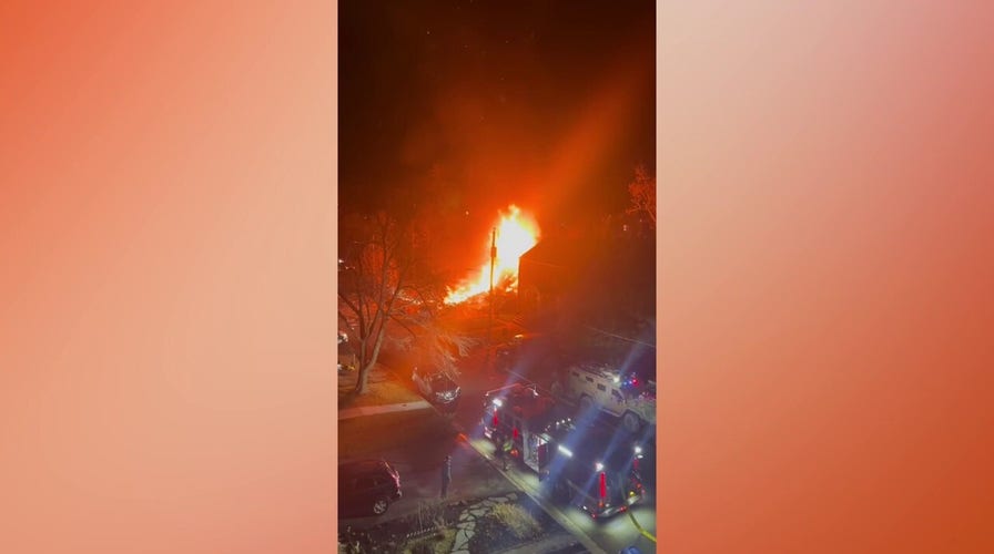An Arlington home was engulfed in flames after an explosion as cops were trying to serve a search warrant.
