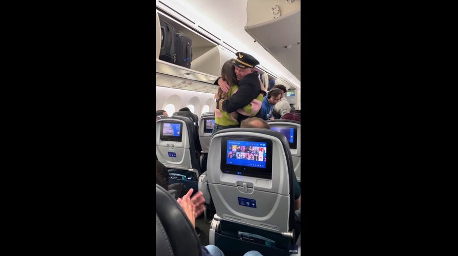 United Airlines pilot hugs the passenger who saved his life with bone marrow donation