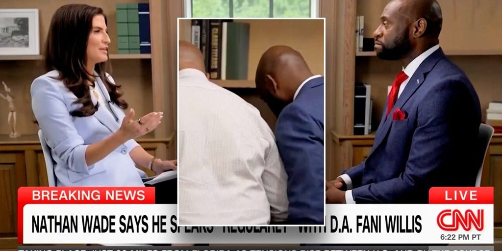 Nathan Wade pauses CNN interview to speak with consultant