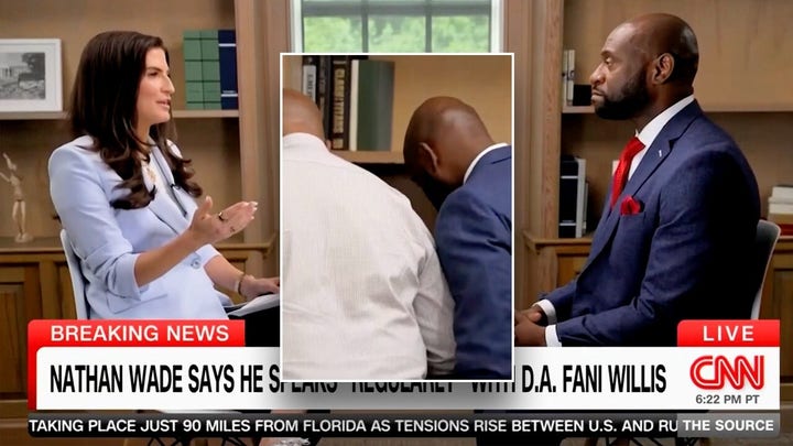 Nathan Wade pauses CNN interview to speak with consultant