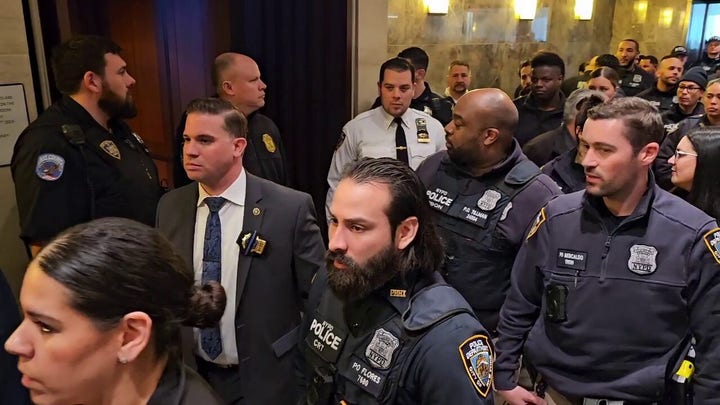 NYPD officers show up in court for suspect in cop slaying.
