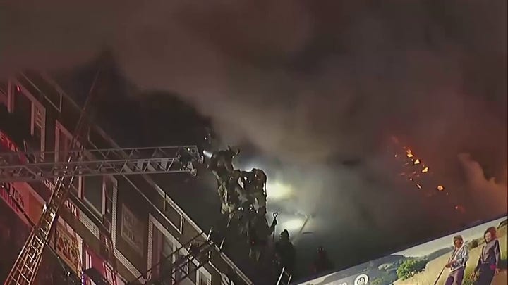 Los Angeles firefighters battle a blaze at a Westlake District apartment complex